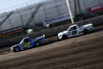 Carson Hocevar and Chandler Smith drive during qualifying for the NASCAR Camping World Truck Series Clean Harbors 150