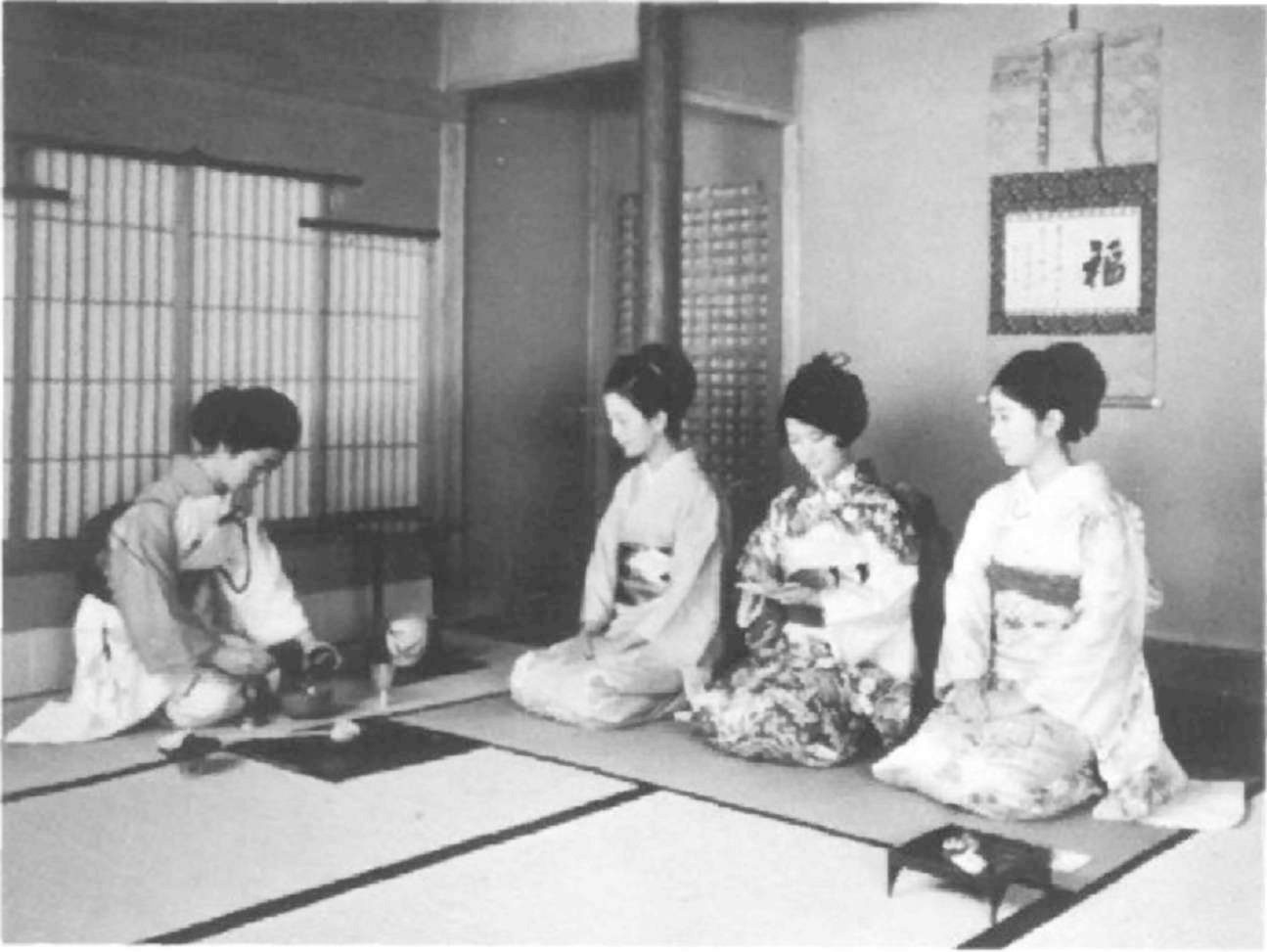 Host and guests at a tea ceremony. title=