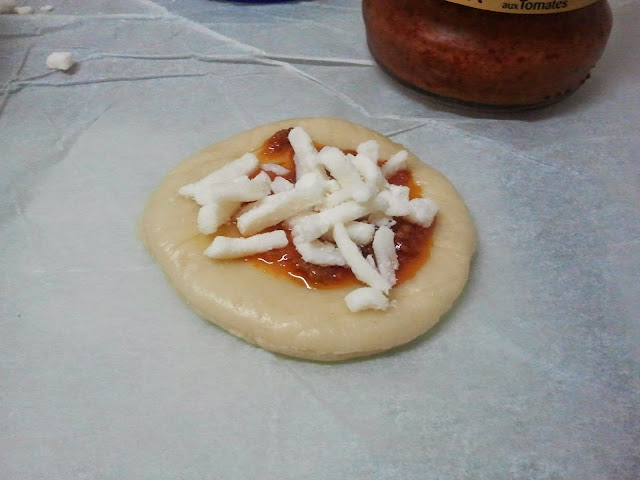 sprinkling cheese on brioche circle