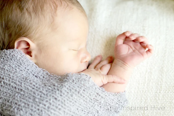 Our natural birth story- a quick labor with a surprising ending. Grey newborn wrap photography.