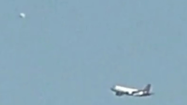 White UFO Orb nearly hits a commercial airplane over Brussels in Belgium Europe.