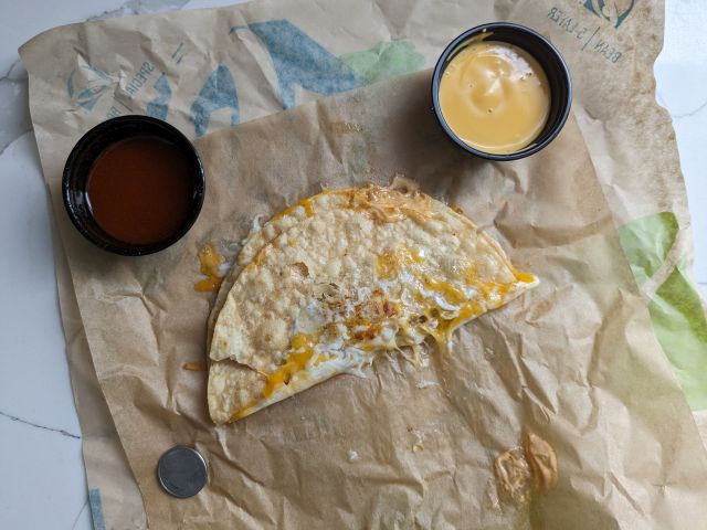 Taco Bell Grilled Cheese Dipping Taco with dipping sauces.
