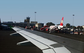 airport building with aircraft on tarmac