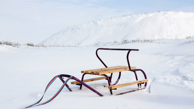 a wood and metal sled waiting for a rider