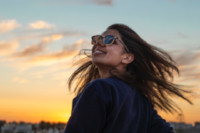 smiling woman wearing blue sunglasses (trimmed)