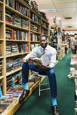 Mayor Randall Woodfin surrounded by books