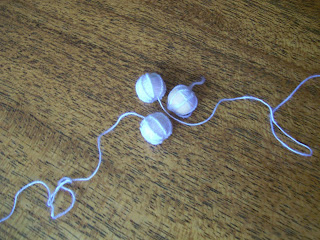 Thread-covered buttons: linen over wooden beads.
