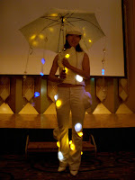 Model wearing light-emitting clothes for rainy weather in 高松 (Takamatsu)