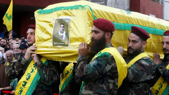 Hezbollah members carry the coffin of Hassan Youssef Abdel Sater who was killed on Friday in an Israeli strike on Beirut's southern suburbs