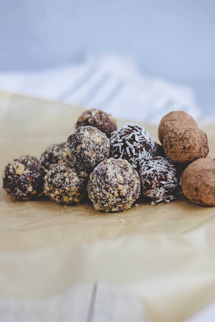 Dark chocolate truffles with coconut and chopped nut toppings