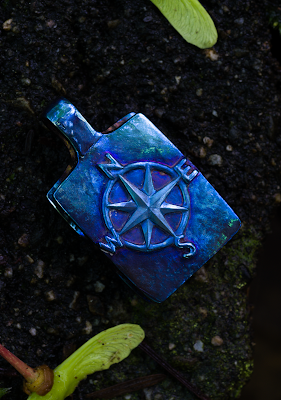 Titanium pendant hand with hand engraved compass rose.