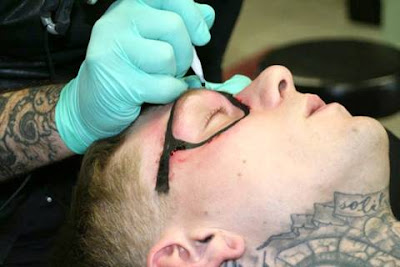 A Guy Gets His Face Tattoed