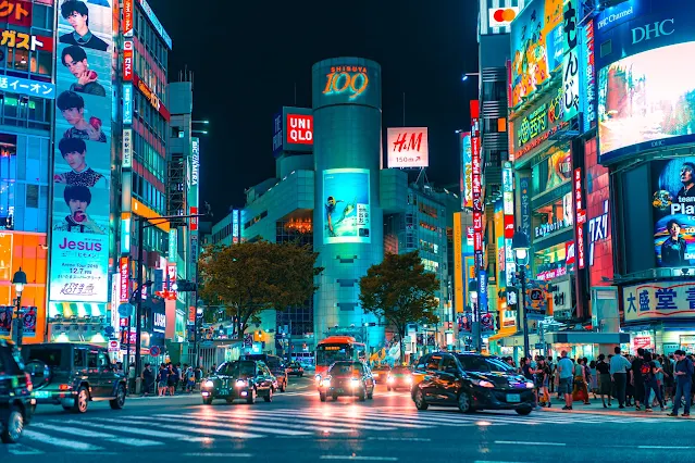 night time in tokyo with building all illuminated with bright colours