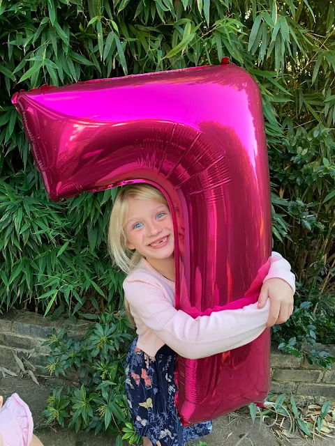 A 7 year old and her birthday balloon