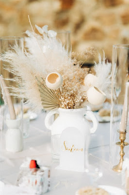 centerpiece in white jar with pampas and abstract wooden floral