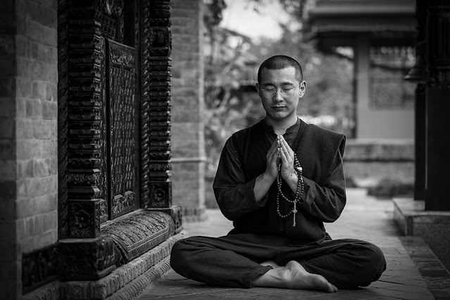 A Monk meditates to open the spiritual power.