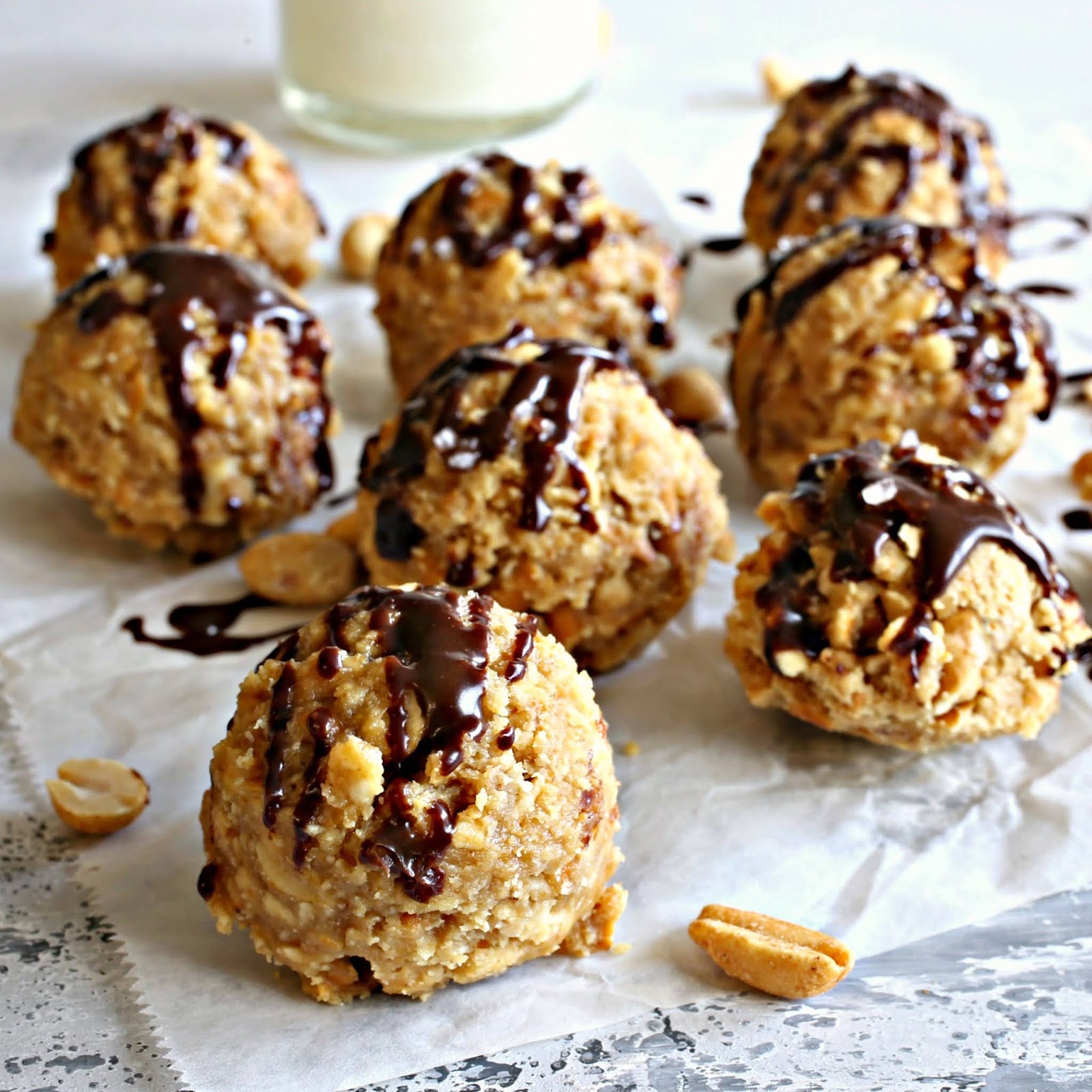 Peanut butter balls filled with pretzels and peanuts, topped with melted chocolate.