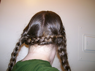 Front braids pinned across the back of the head.