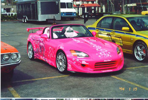 Suki's car has a Veilside body kit a custom pink paint job and a great big