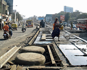 woman watering cement on concrete road