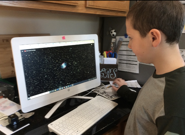 Plymouth South Elementary School Student, Aidan F., examines his image of M27, The Dumbbell Nebula, taken on Insight Observatory's 16 f/3.7 astrograph reflector (ATEO-1) remote telescope.
