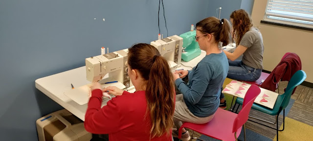 Moms sewing blocks for an Exploding Heart quilt