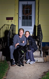 couple and dog on a stoop at night