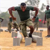 A humorous image of Fit Tumbler hilariously attempting the obstacle course during Nigeria Army Shortlist 2021 81RRI training.