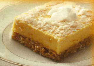 Custard tart on a crushed ginger biscuit base served dusted with toasted coconut and a dollop of sour cream