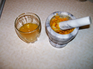 Juicing an orange and mashing the peel.