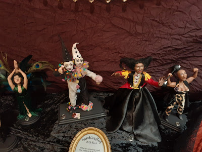 Circus dolls of a two headed clown; a weight-lifting three-breasted transgender; and two female dancers.