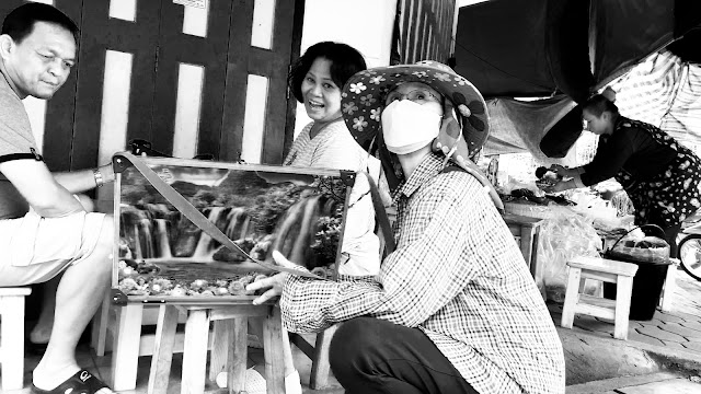 Lottery ticket seller and couple in street restaurant