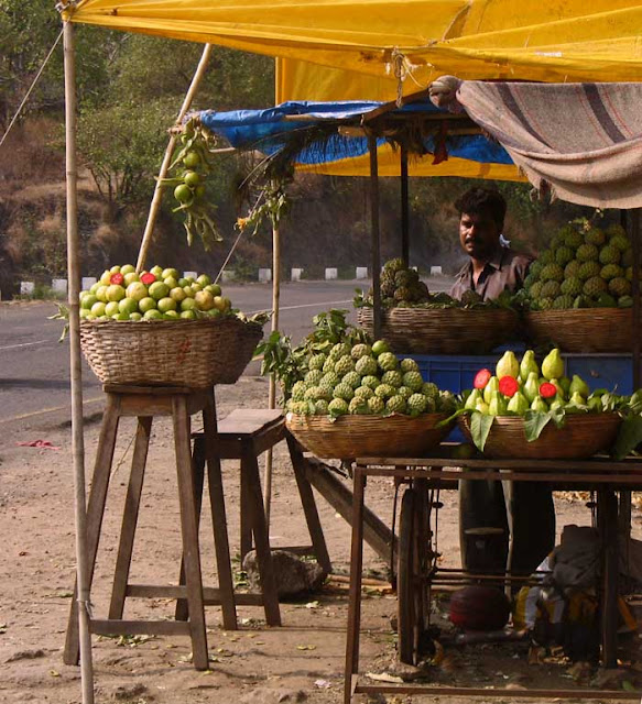 fruit vendor selling guavas and custard apples