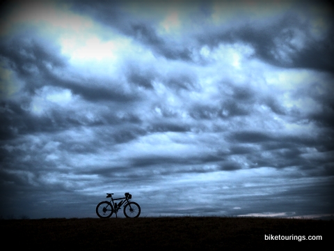 Picture of mountain bike on hill top cloud scenic