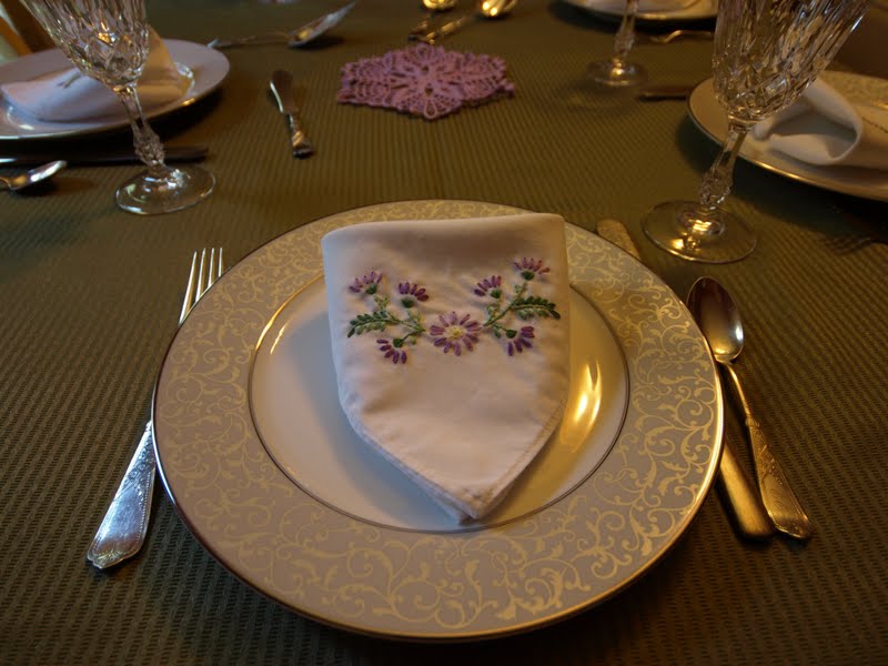 Purple and green on the dinner table plus silver wedding china 