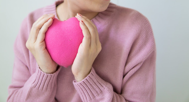 Lady holding a heart shape