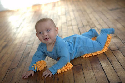 Kid child cleans the floor with clothes outtfit