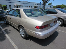 1999 Camry with multiple shades of paint & peeling paint.