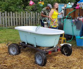 Just So Festival Mobile bathtub shown refilling and reheating the water between bathers