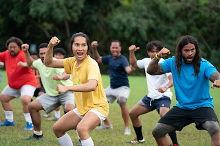 Kaimana and the cast of NEXT GOAL WINS. Photo by Hilary Bronwyn Gayle. Courtesy of Searchlight Pictures. © 2022 20th Century Studios All Rights Reserved.