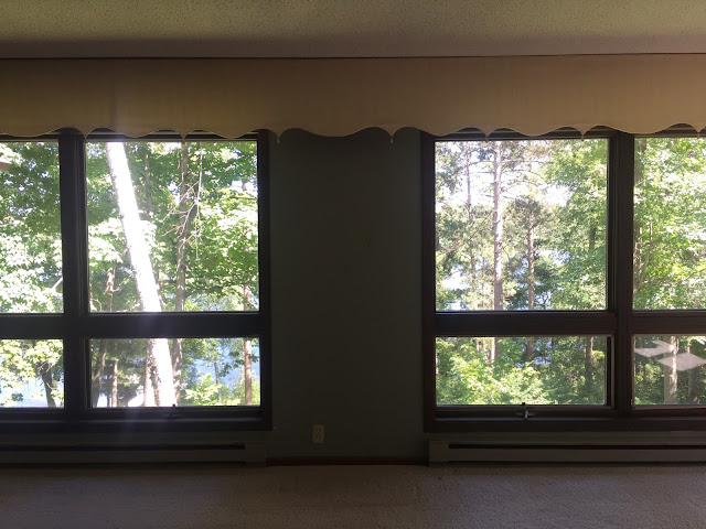 lakeside living room with floor to ceiling windows