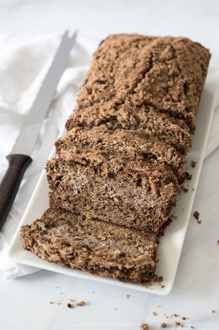 Banana bread on plate and serrated knife