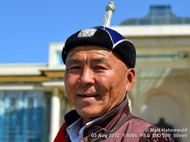 people, portrait, headshot, street portrait, Mongolia, Ulaanbaatar, Chinggis Khaan Square, Mongolian man, traditional Mongolian costume, traditional Mongolian hat, Mongolian deel