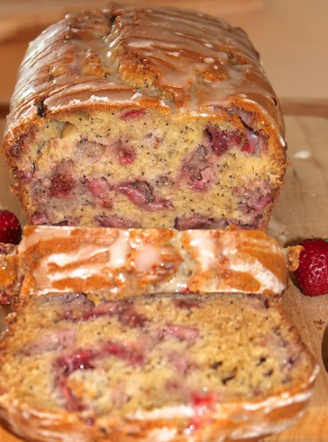 Loaf of lemon glazed strawberry poppy seed bread.