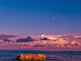 A stormy sky over Green Bay, the moon just visible in the sky