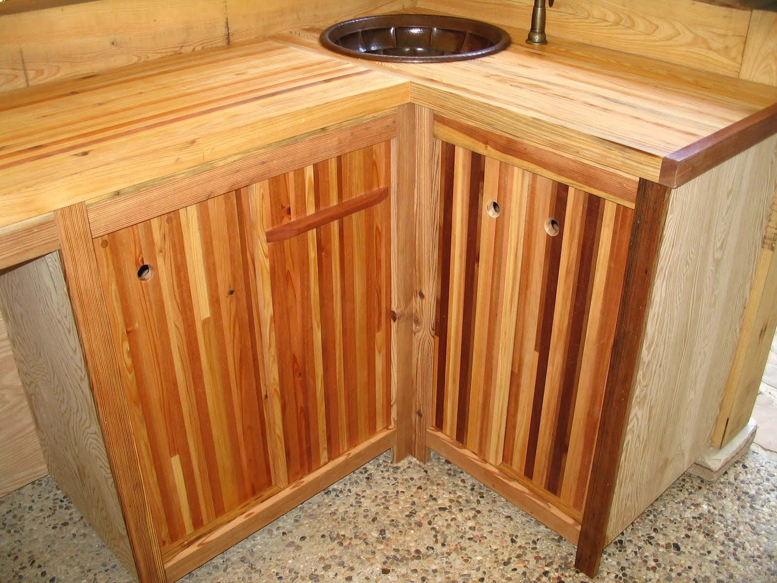 The counter features a hand made copper sink and a sprayer