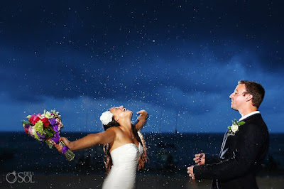 Bride embracing the rain and getting soaked