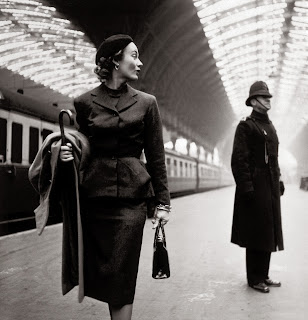 Lisa Fonssagrives with an English bobby on a railway station platform | Toni Frissell | Harper's Bazaar, 1951 | Library of Congress