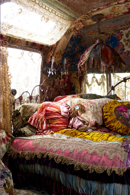 This is Bohemian gypsy to the extreme. The ornate linens, lace, fringe ...