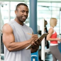 Black male muscular personal trainer holding a clip board